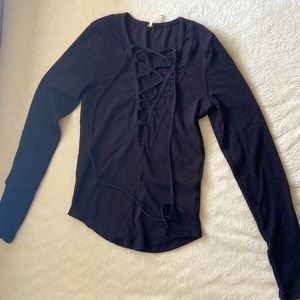 Free people, tight fitting, low cut, long sleeve black shirt.
